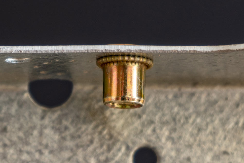 Rivet nut installed in metal