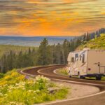 RV traveling on road with beautiful mountain view